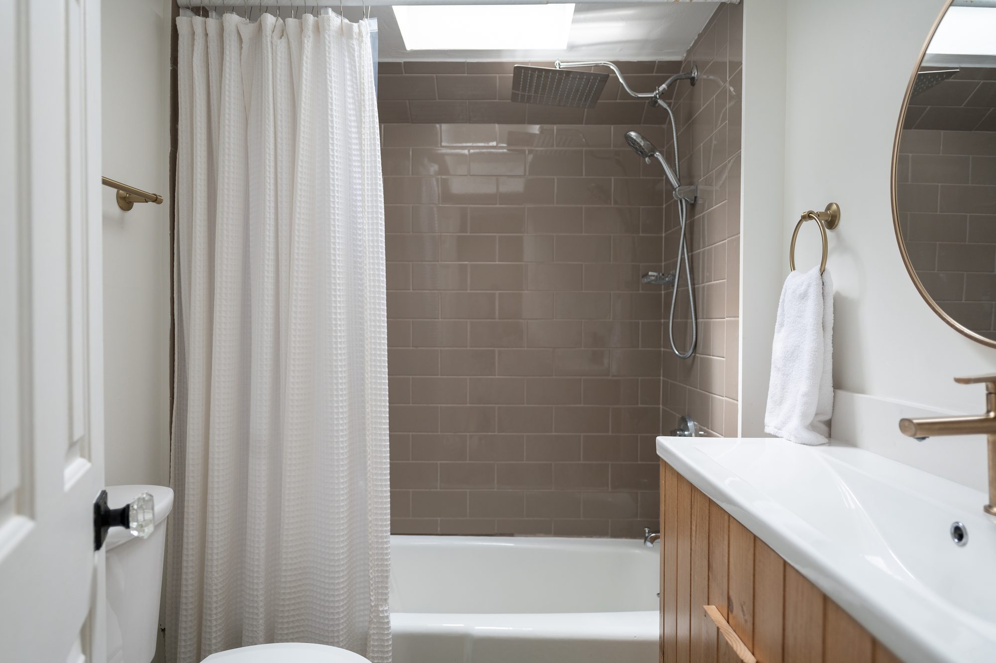 Renovated bathroom with subway tile and soaking tub