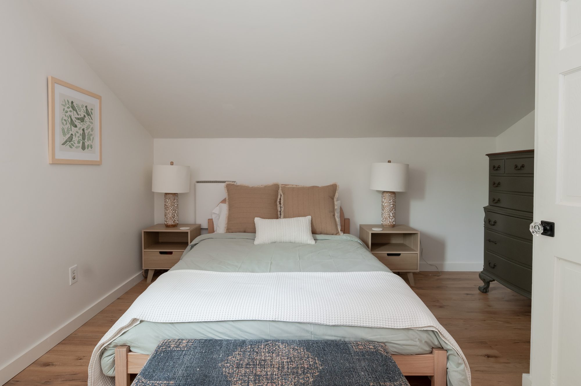 Bedroom three with hardwood floors and natural light