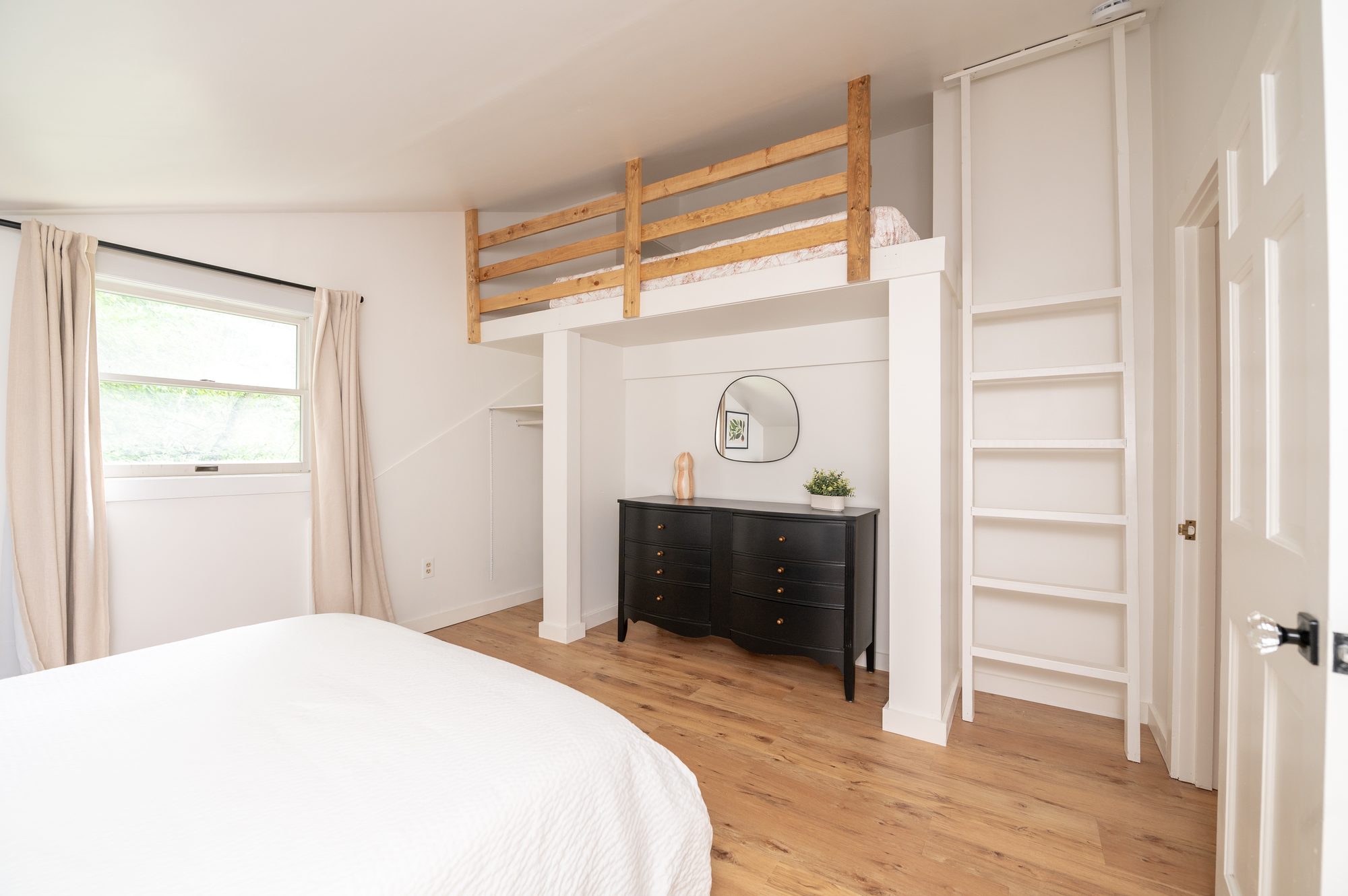 Bedroom with queen bed and sleeping loft