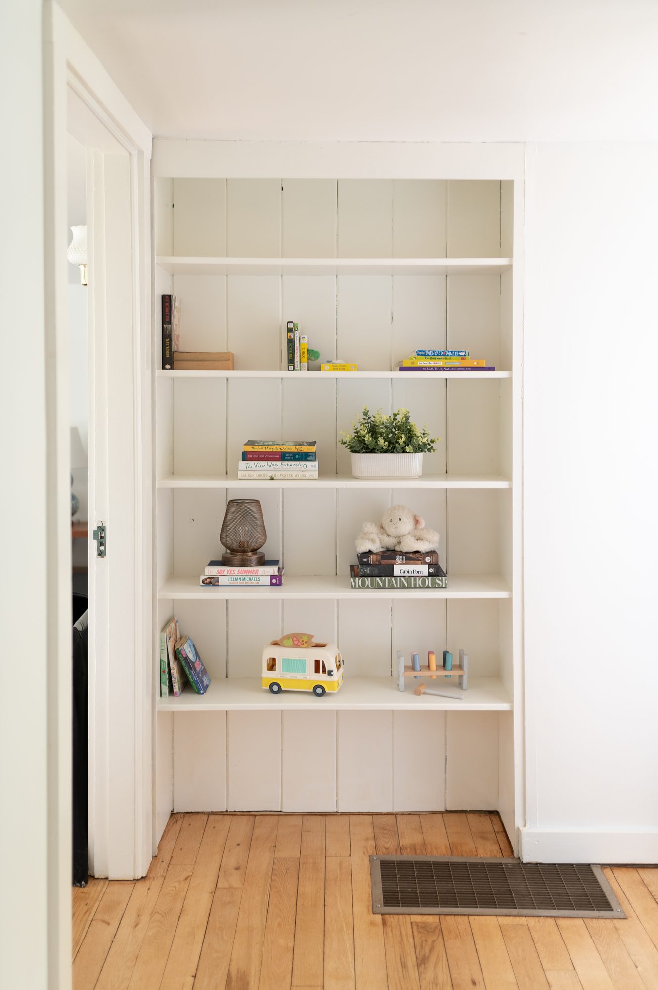 Bookshelf stocked with books, games and toys