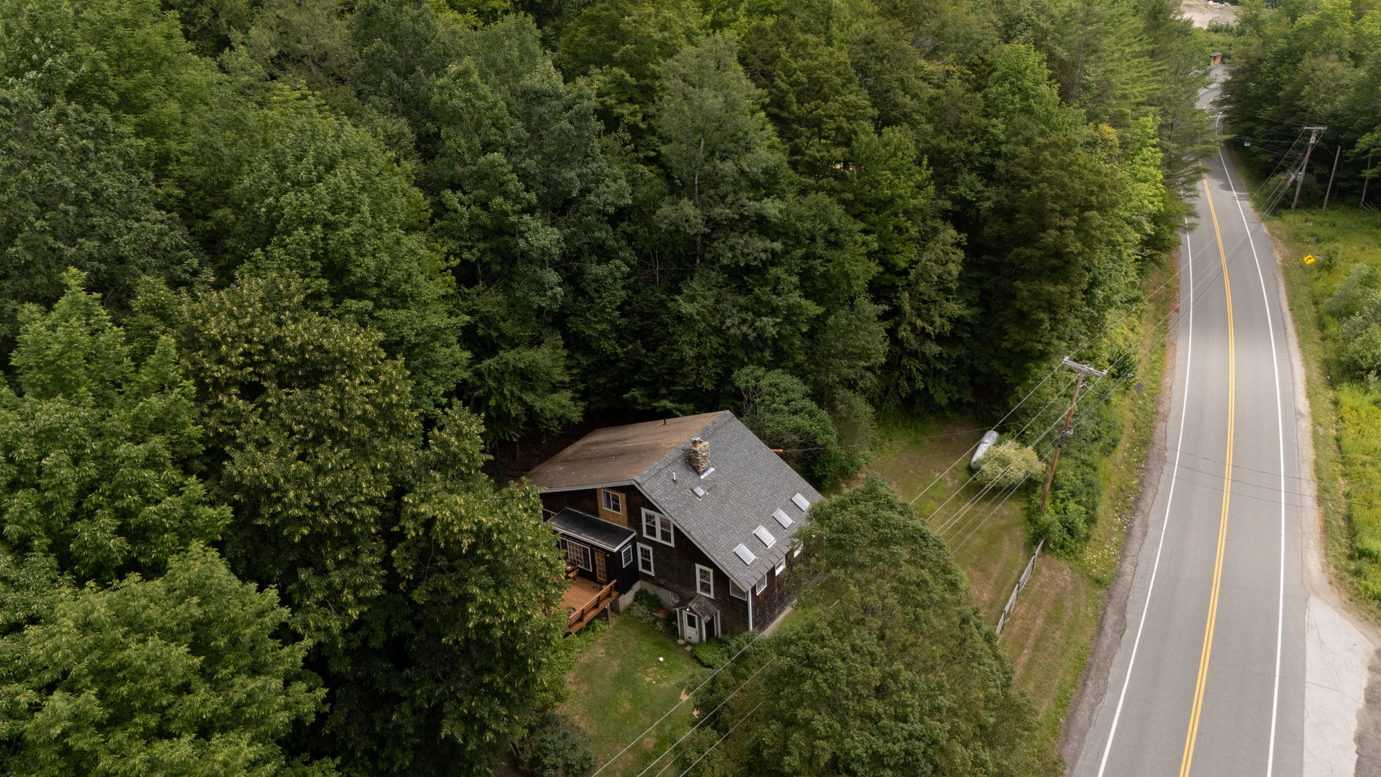 Aerial view of Cedar Mountain Chalet along the winding Vermont mountain road