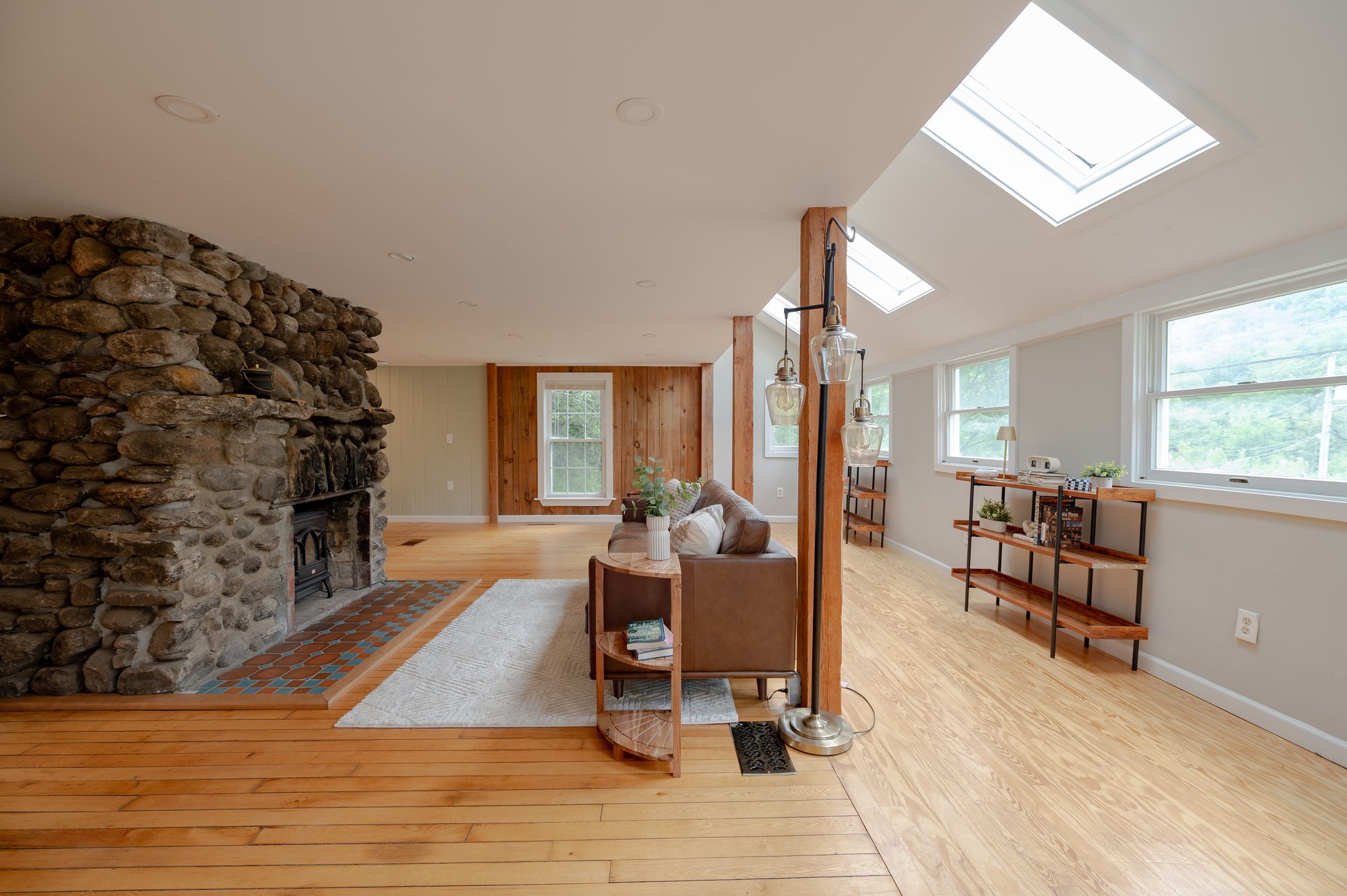The 100-year-old stone fireplace and open living room
