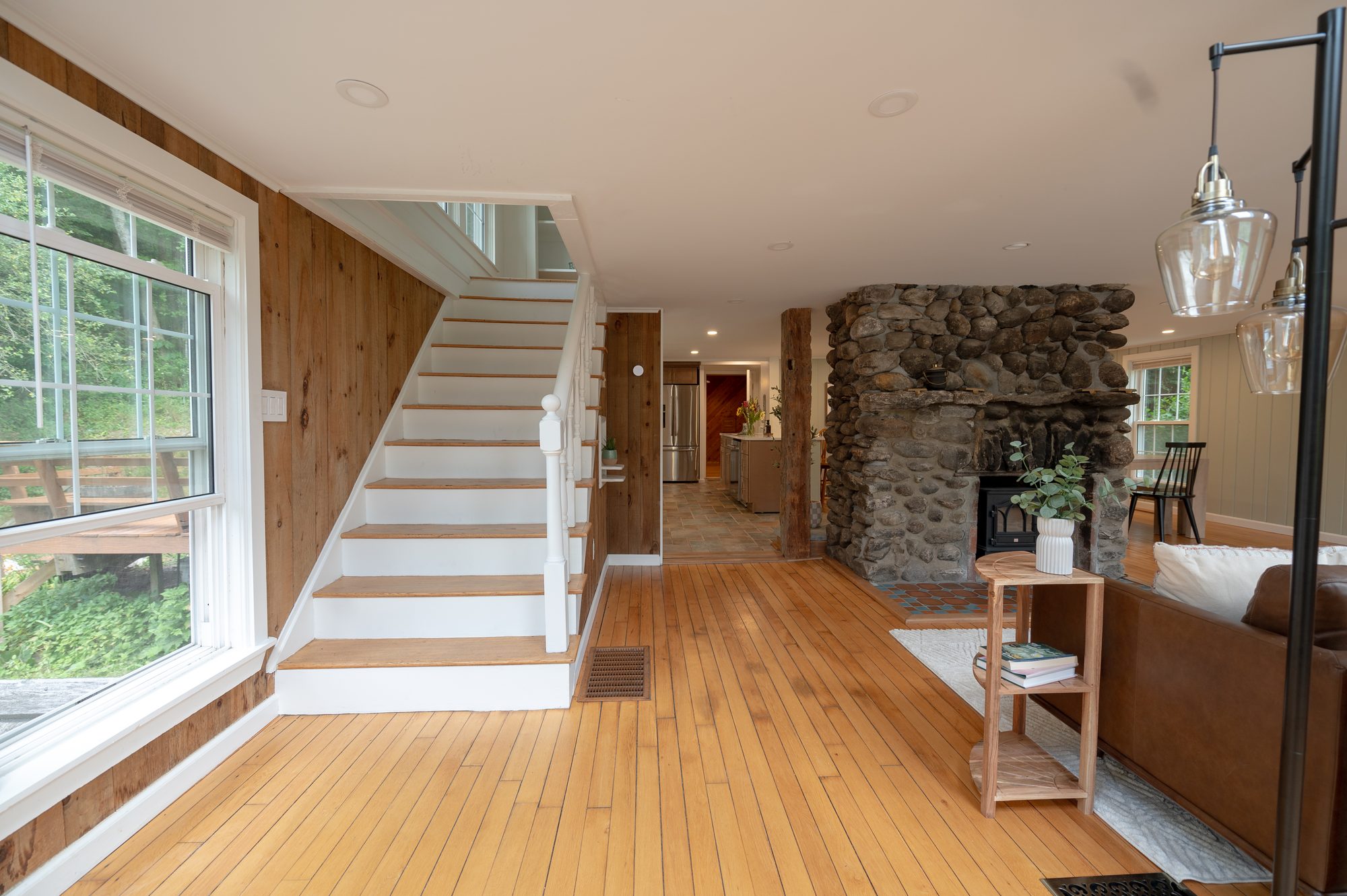 Open-plan living area with staircase and fireplace