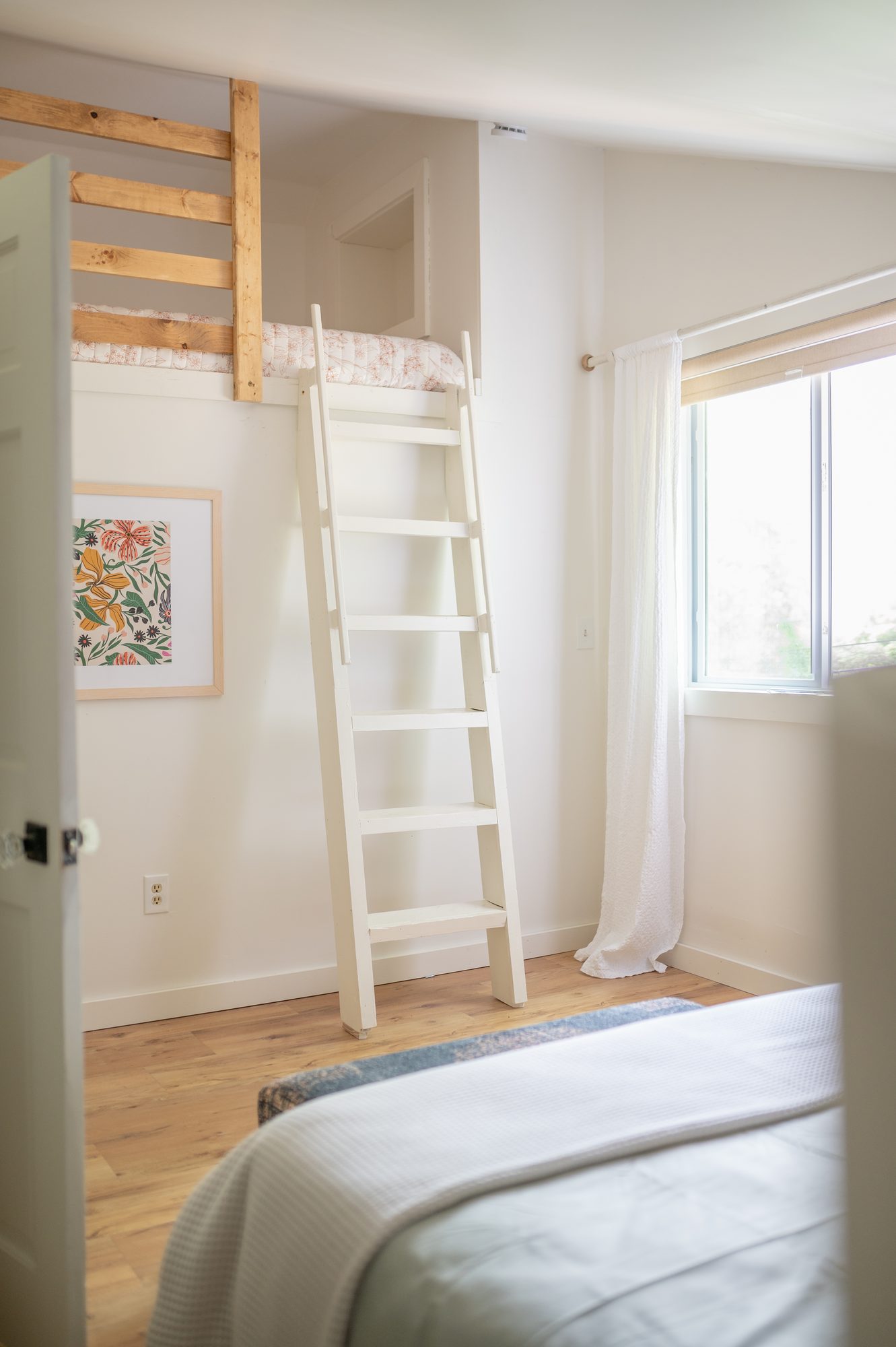 Loft bedroom ladder and botanical wall art